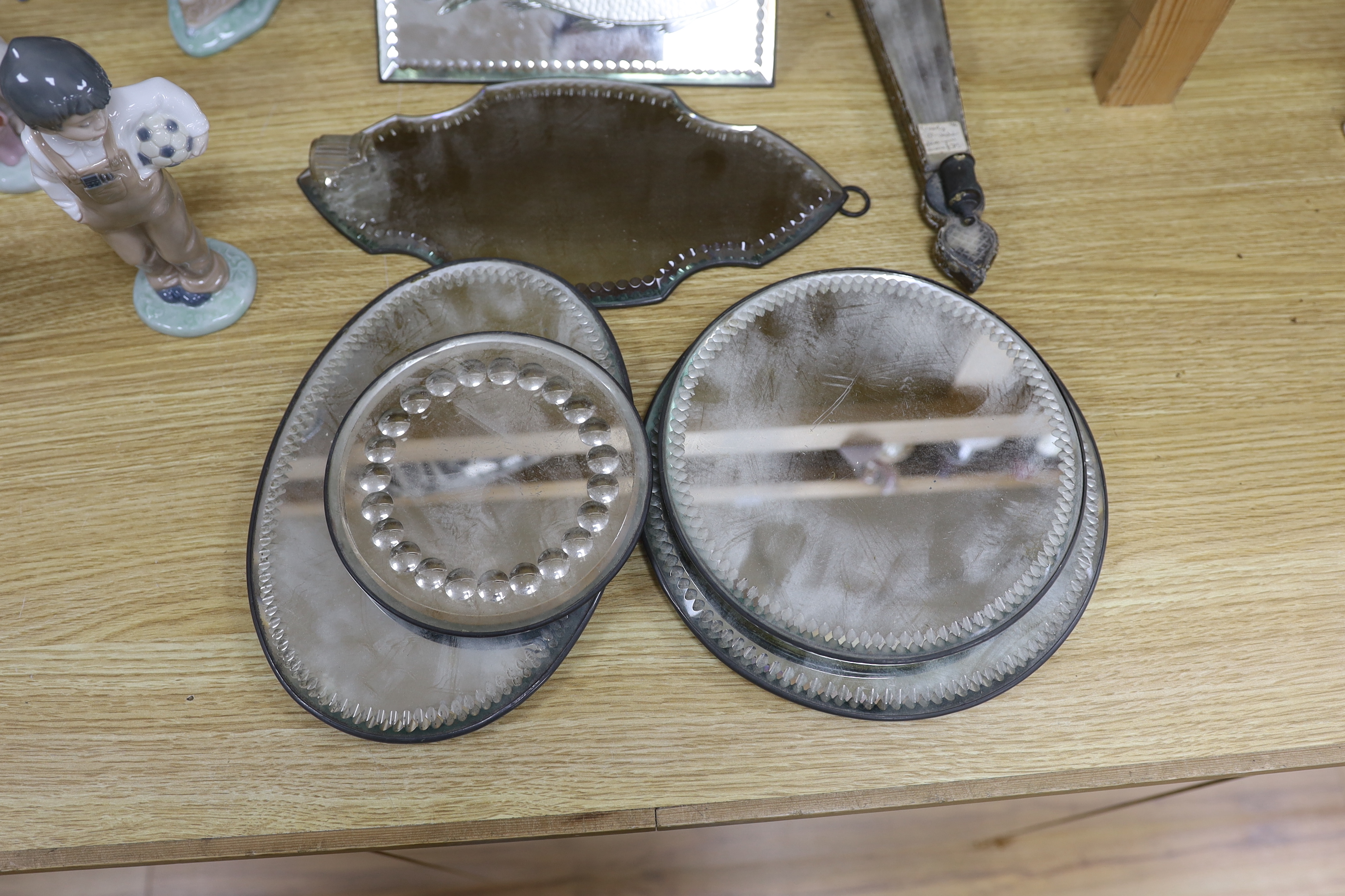 A collection of ten various sized and shaped wall mirrors, one with a fish design, 23cm